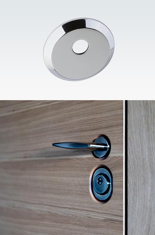 Cilindrinės durų spynos apsaugančio cilindrą įtaiso dalis, tvirtinama išorinėje durų pusėje, tačiau prisukama iš vidinės durų pusės